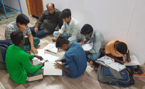Uttam helps the boys of Balavikasita with their homework.