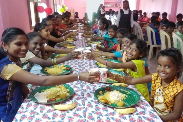 Children at Bethel Orphanage enjoy their Christmas dinner.