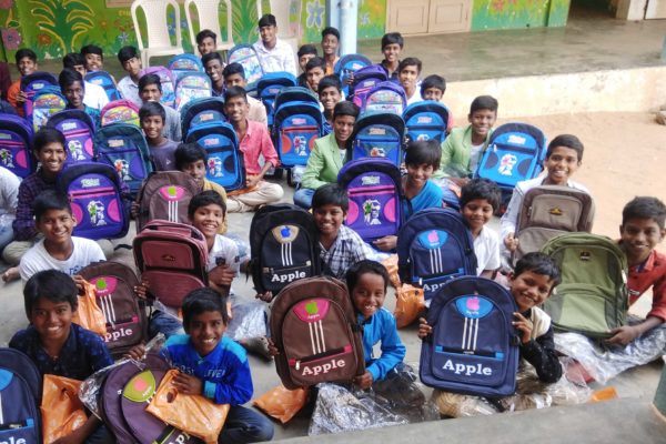 Boys at Bethel Orphanage show off the backpacks they received for Christmas.
