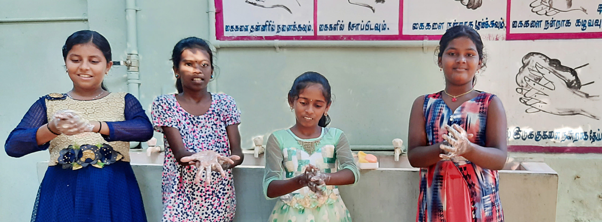 Girls stay healthy by washing their hands at Fatima Home