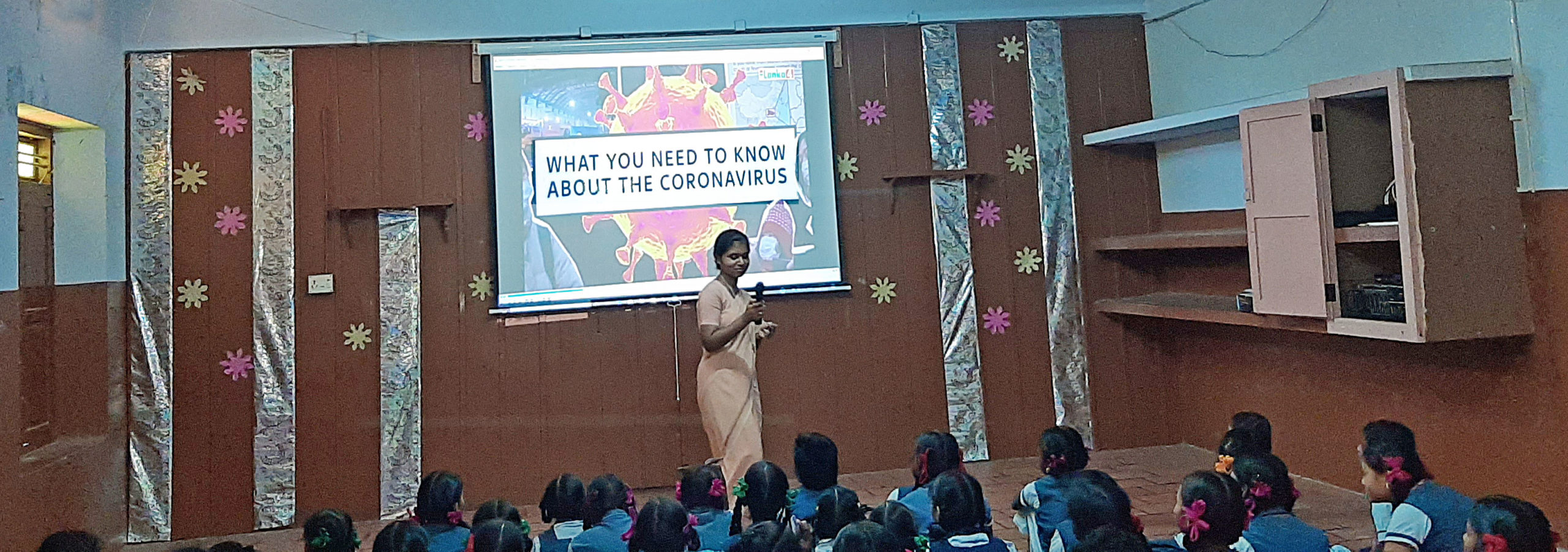 laptop computer, projector, and screen to help educate children