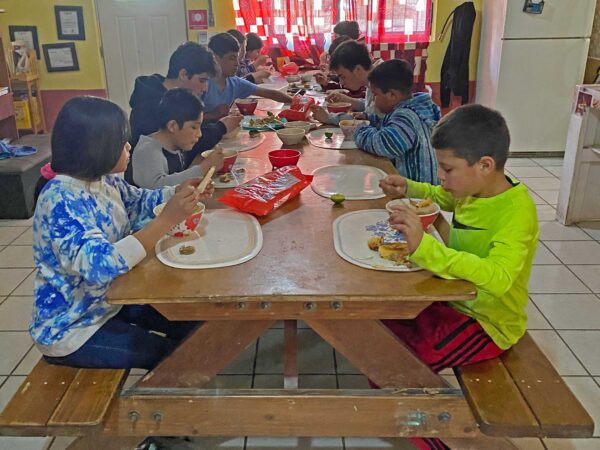 Children eating lunch at Casa Hogar. They need food security.